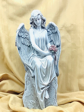 Angel- holding pink flower