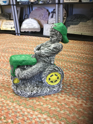 Boy on green tractor.